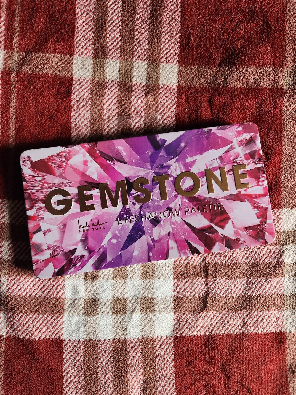 Makeup palette on plaid fabric